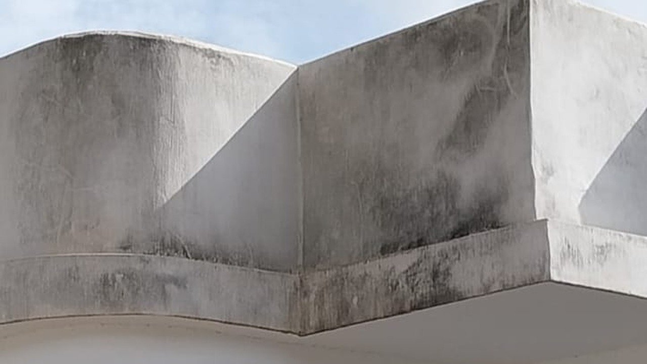 Villa antes de pintar con fachada envejecida por el sol y salitre